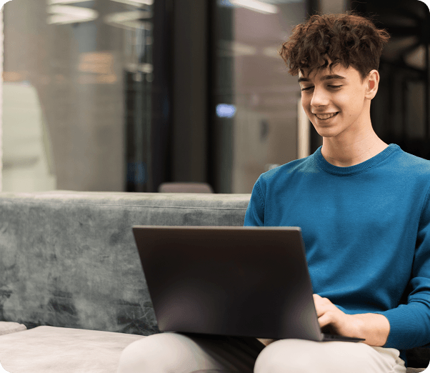 young-smiling-man-working-with-laptop-office